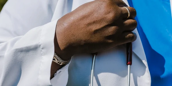 A doctor's hand holding a stethoscope, offering acupuncture in Brooklyn.