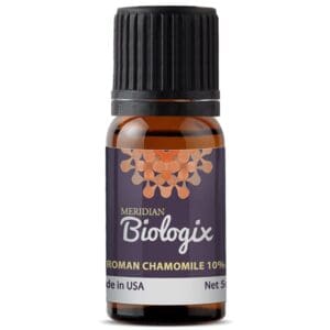 A bottle of SINGLES ROMAN CHAMOMILE 10% (5 ML) (MERIDIAN BIOLOGIX) and chamomile essential oil.