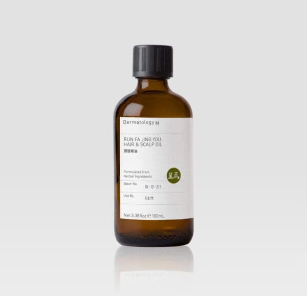 A bottle of RUN FA JING YOU HAIR & SCALP OIL - DERMATOLOGY M on a white background.