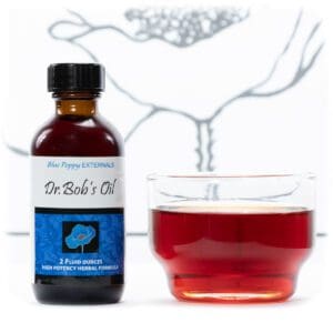 A cup of tea next to a bottle of DR. BOBS (MEDICATED) OIL (BLUE POPPY).