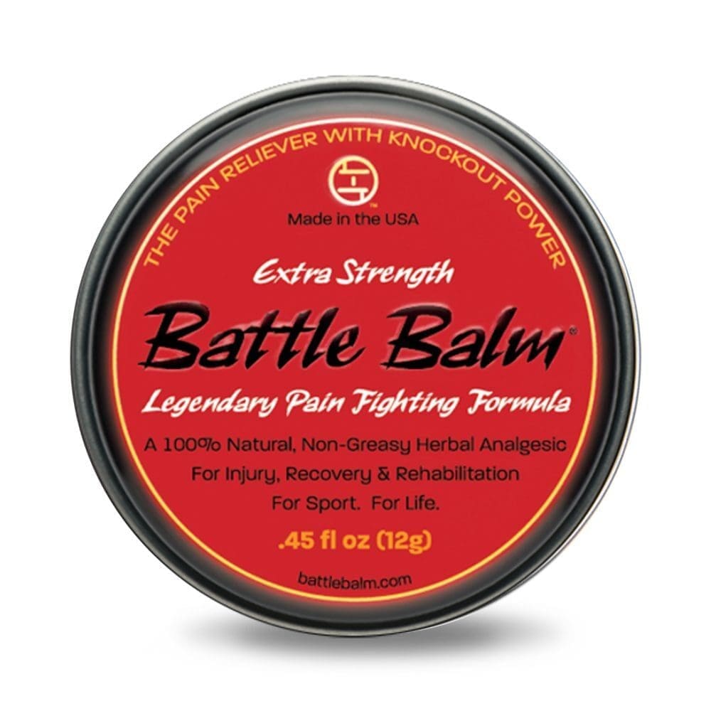 A round tin container labeled "Battle Balm - Extra Strength Legendary Pain Fighting Formula" with a red top. It is a 100% natural, non-greasy herbal analgesic for pain relief, 0.45 fl oz (12g).