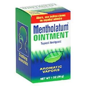 A box of Mentholatum Ointment, a topical analgesic with aromatic vapors, weighing 1 oz (28 g). The packaging is predominantly green and blue with Spanish instructions indicated on the top.