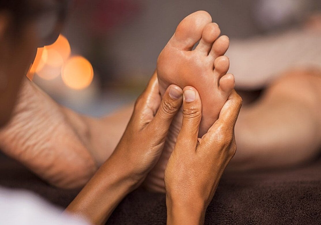 A woman getting a foot massage at a spa.