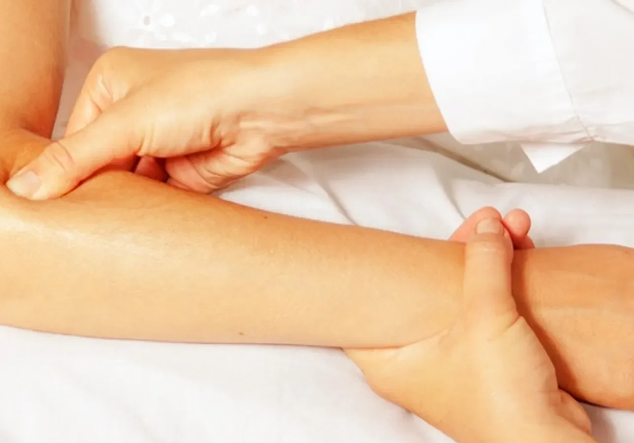 A woman is getting a massage on her arm.