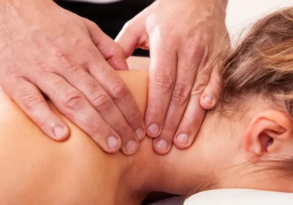 A woman getting a back massage at a spa.