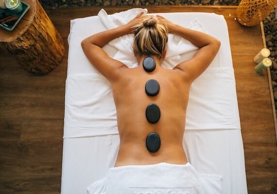A woman receiving a hot stone massage at a spa in Brooklyn.
