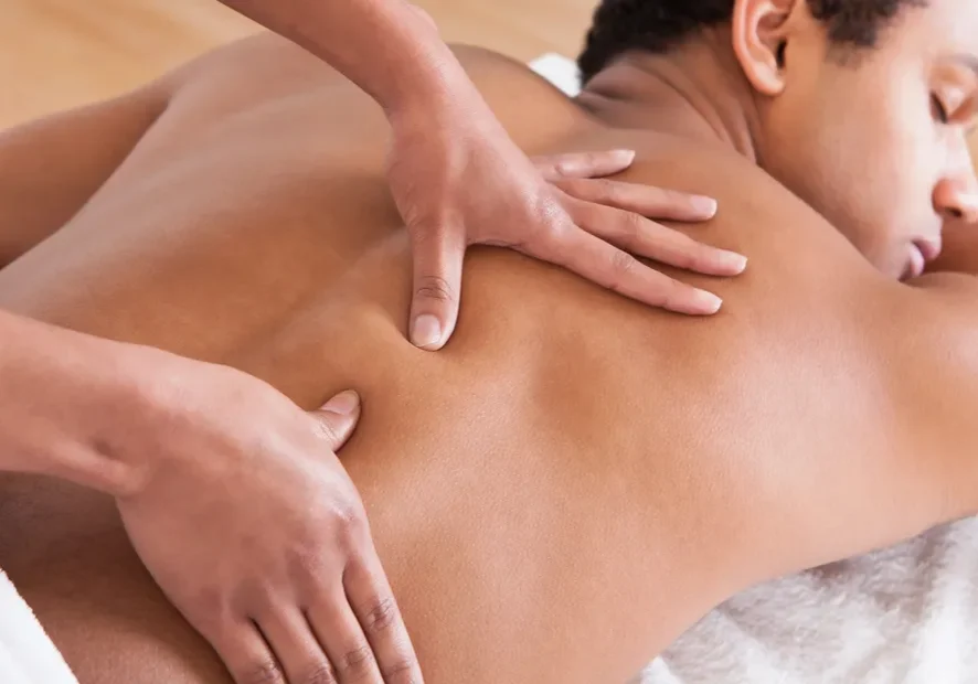 A man getting a back massage at a spa.