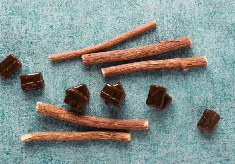 A group of licorice sticks on a blue background.